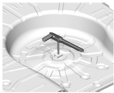 Entreposage d'un pneu crevé ou d'un pneu de secours et des outils